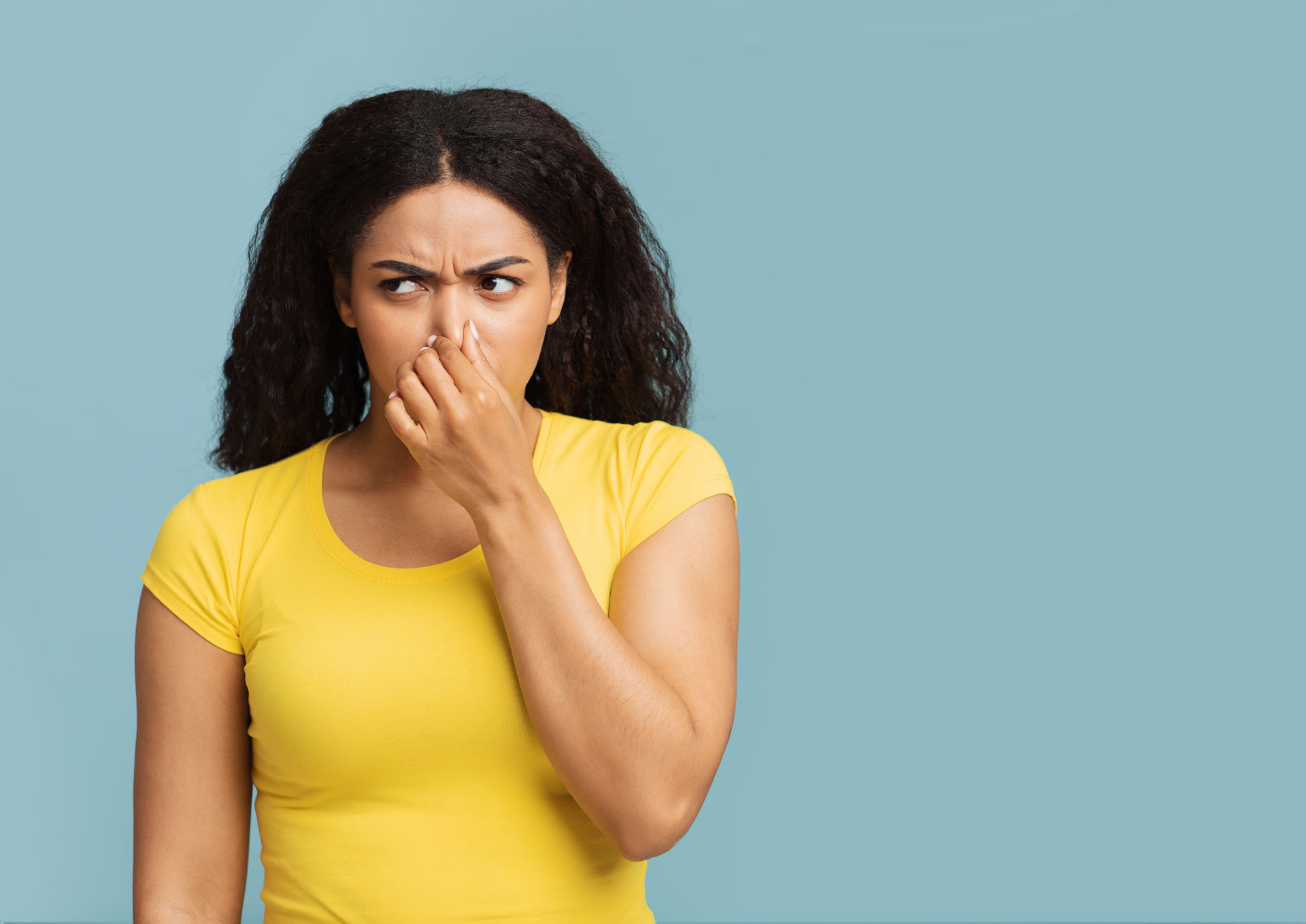 Photo of Woman Pinching Her Nose With Her Fingers