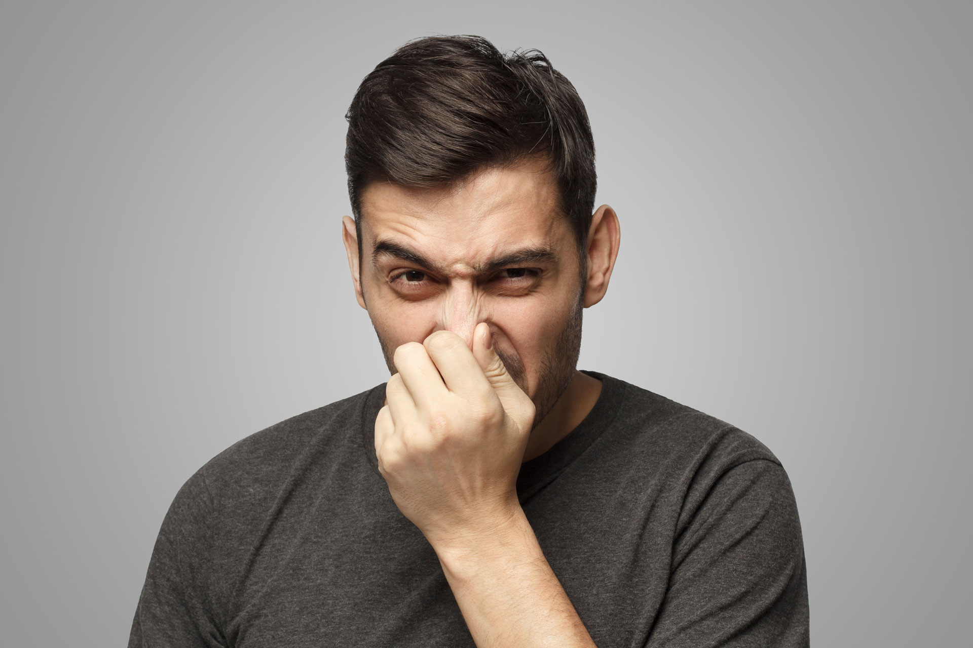 Photo of Man Pinching His Nose With His Fingers